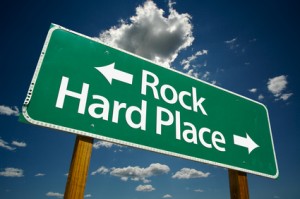 "Rock, Hard Place" Road Sign with dramatic clouds and sky.